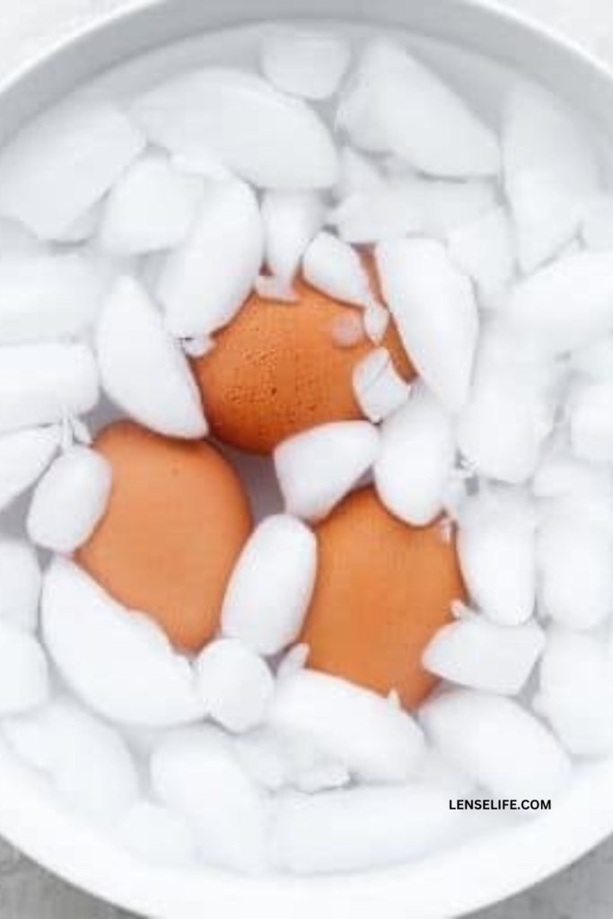 Placing the boiled eggs in ice water for cooling