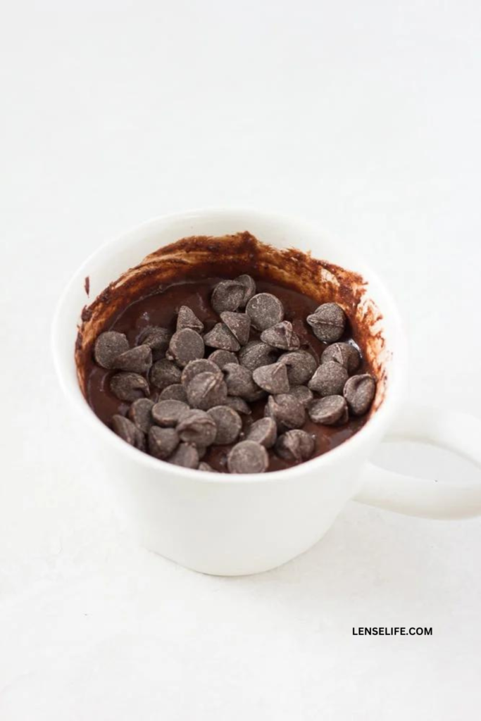 Adding some extra chocolate chips for Chocolate Mug Cake 