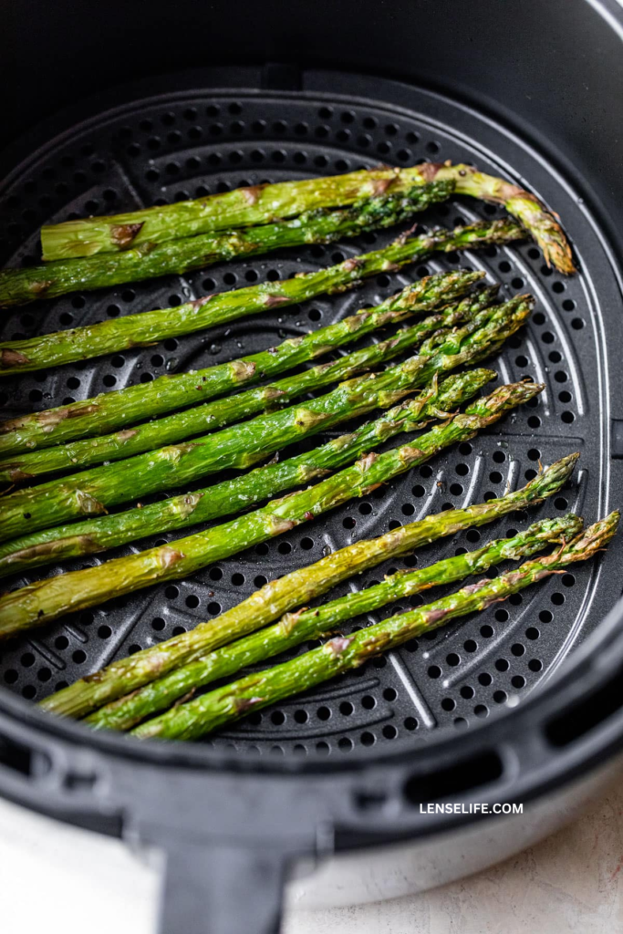 tender asparagus in air fryer basket