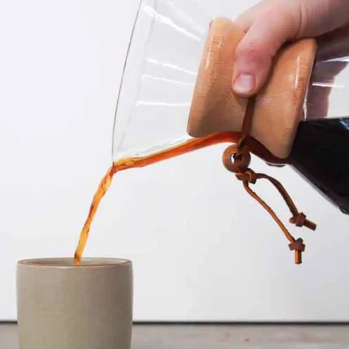 pouring brewed coffee into a mug