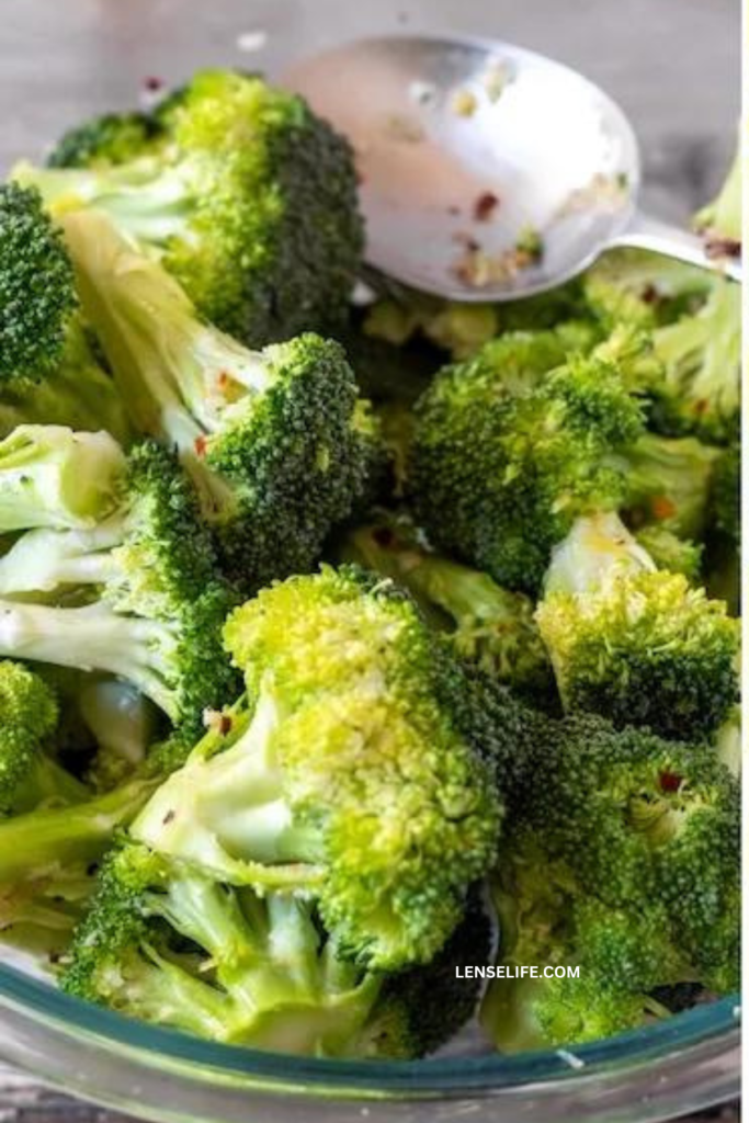 seasoning the broccoli in a bowl