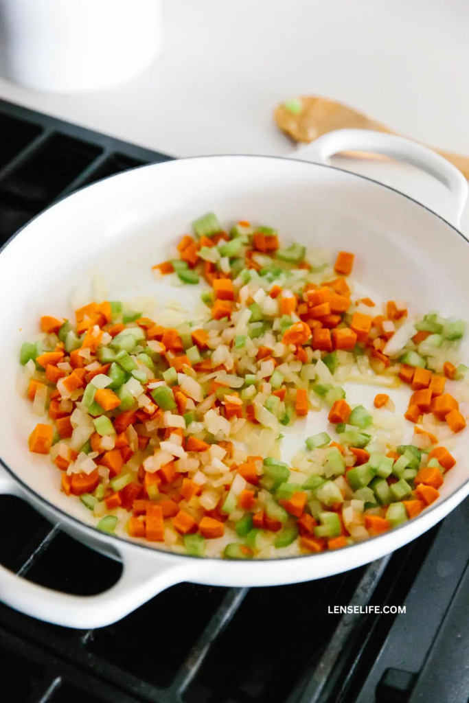 sautéing the vegetables in a pan