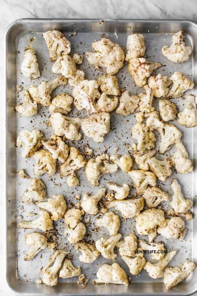 single layer of cauliflower in a baking tray