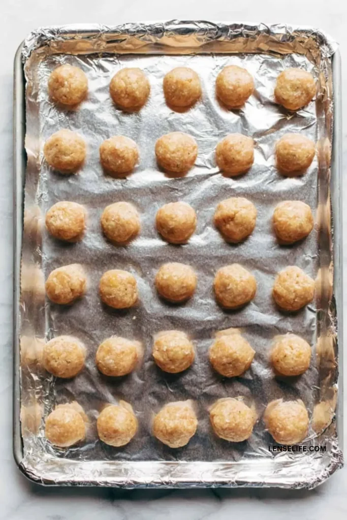 meatballs lined up in a baking tray