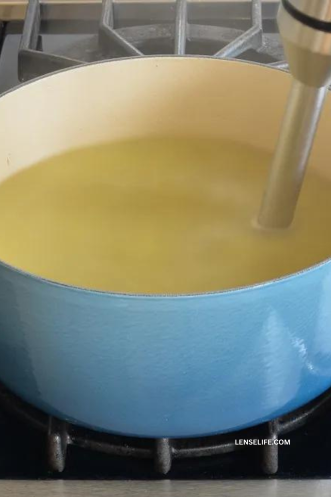 blending the soup in a pot