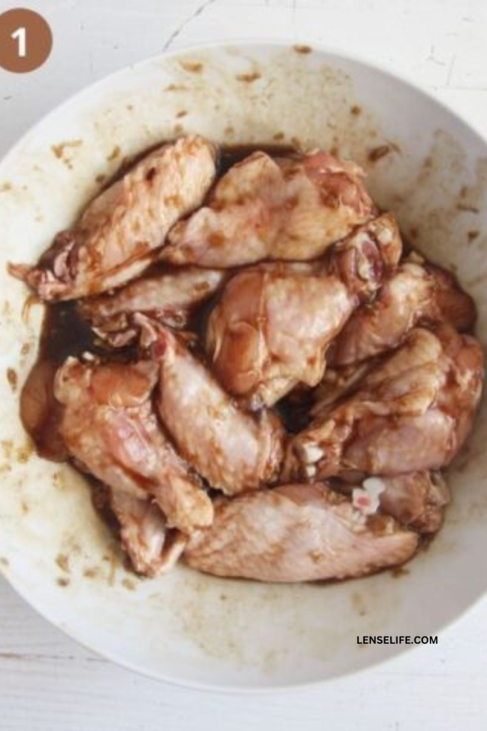 seasoning the chicken in a bowl