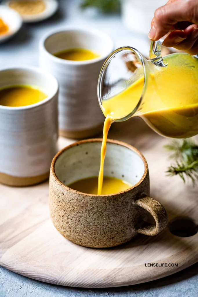 pouring golden milk into cups