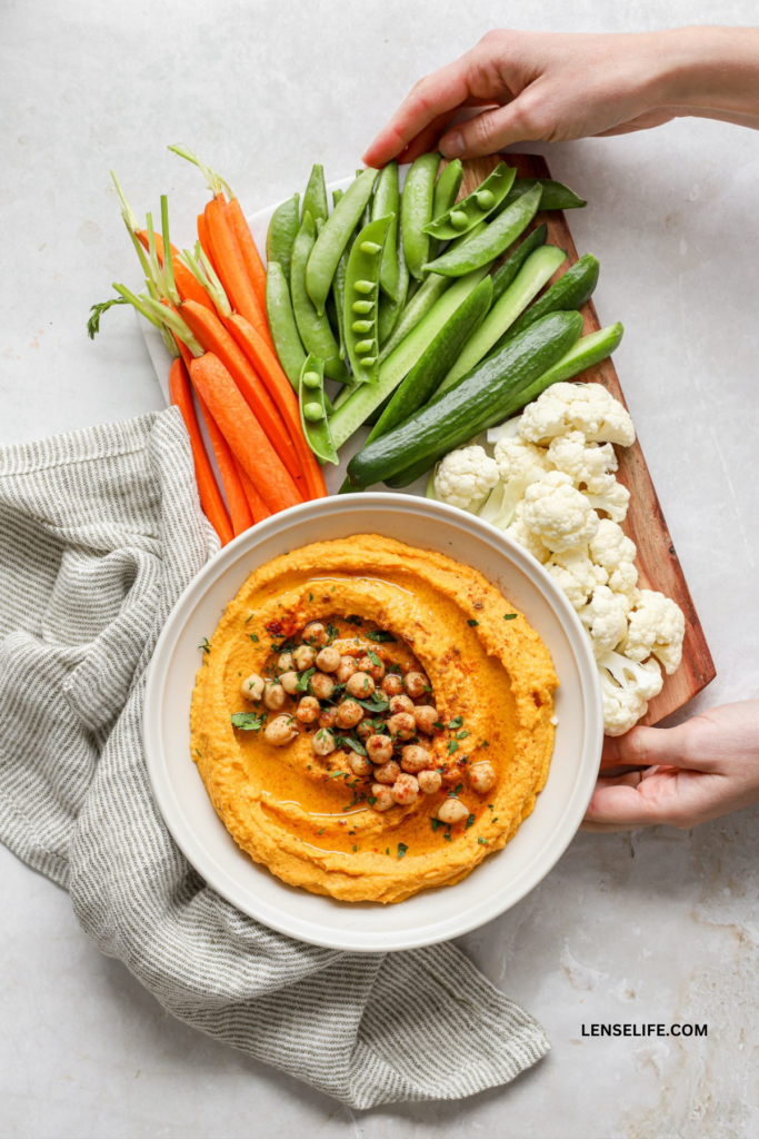 Roasted Carrot Hummus topped with chickpeas in a bowl