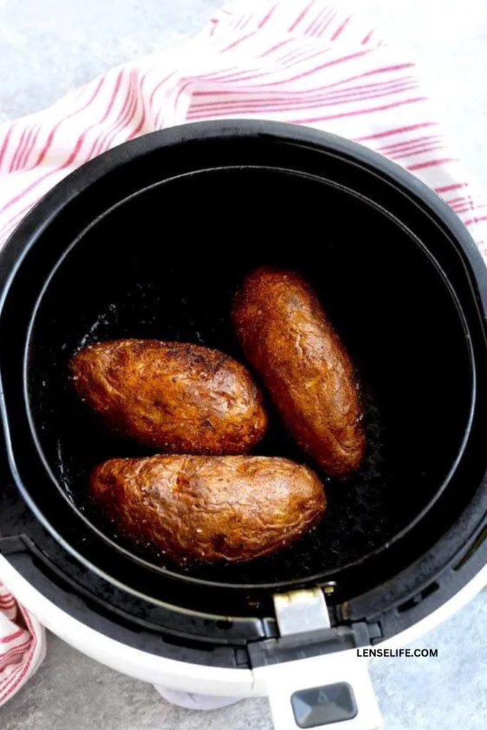 Air Fryer Baked Potatoes in the air fryer basket