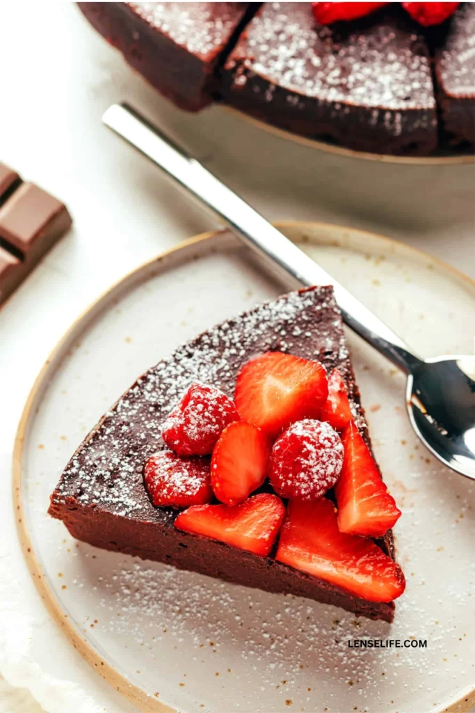 Flourless Chocolate Cake topped with berries served in a plate