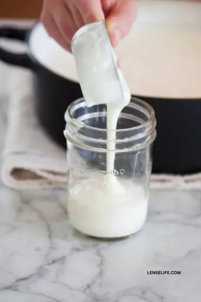 pouring yogurt into jars